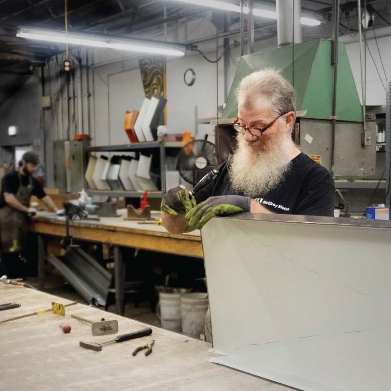 A person working in a sheet metal shop